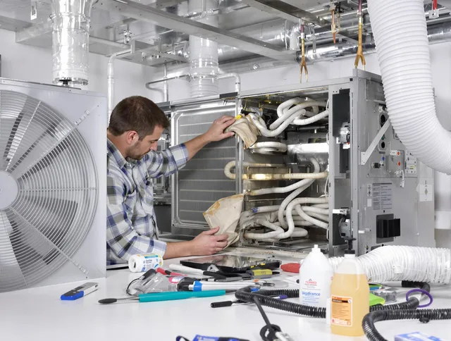 Hudson Air Duct Cleaning specialist performing precision AC coil cleaning in Hudson
