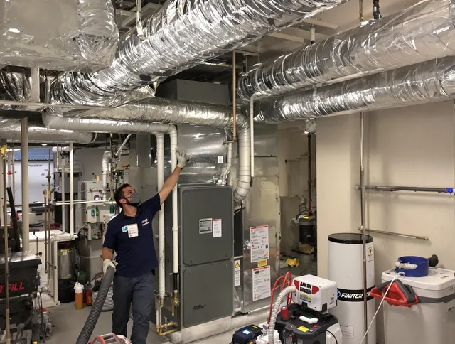 Hudson Air Duct Cleaning specialist performing thorough furnace duct cleaning in a Hudson residence
