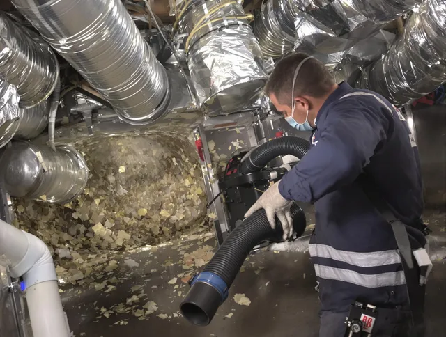 Hudson Air Duct Cleaning specialist operating negative pressure cleaning equipment for thorough duct maintenance in Hudson