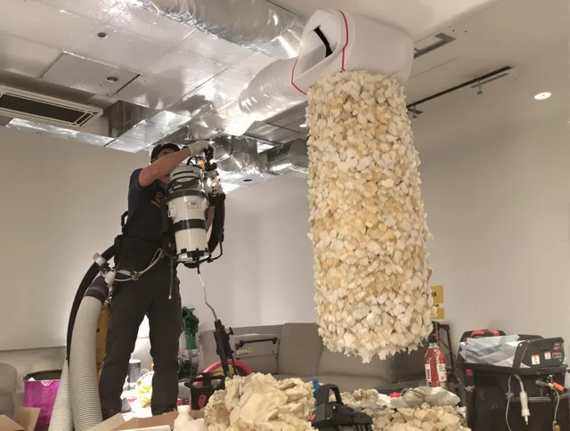 Hudson Air Duct Cleaning technician performing precision vacuum insulation removal in a residential property in Hudson